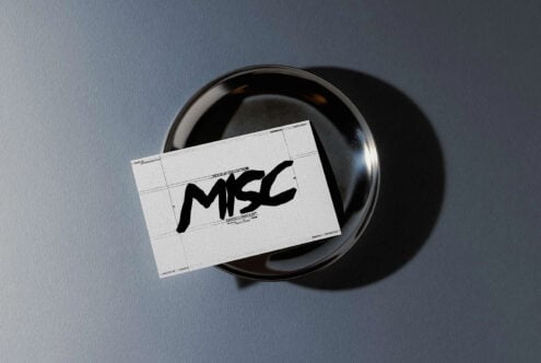 Business card mockup with black bowl on blue gray background showing MSC logo