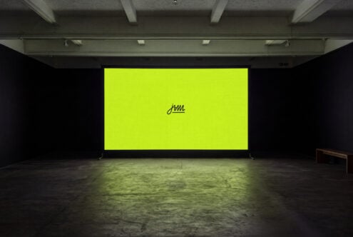 Neon yellow billboard mockup in industrial gallery space with concrete floor