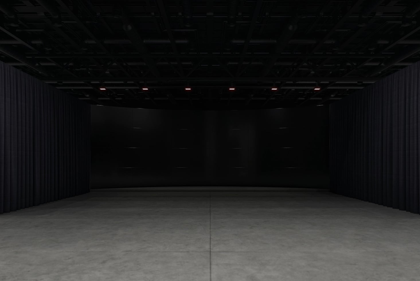 Empty warehouse studio with concrete floor, black curtains, industrial ceiling