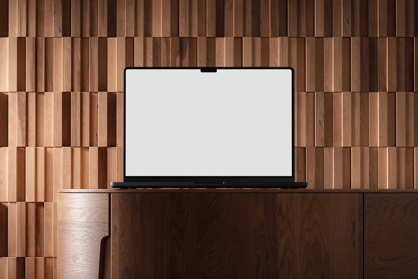 Laptop mockup on wooden desk with geometric wood wall backdrop, blank screen ready for designs