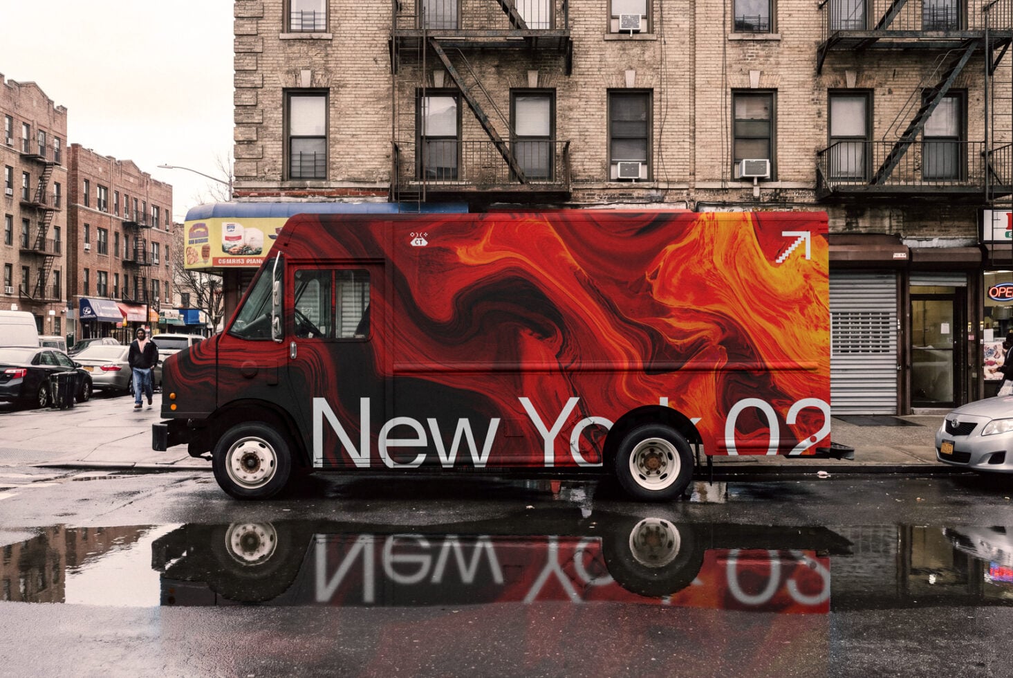 Red food truck with liquid marble wrap on NYC street with brick buildings