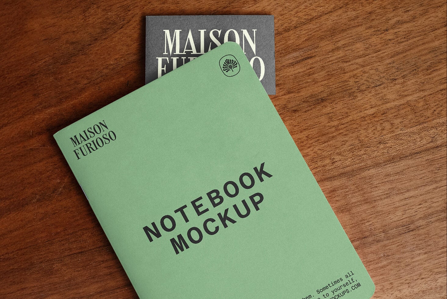 Mint green notebook with "Maison Furioso" branding, small leaf logo on cover, styled on wood surface with matching business card behind it