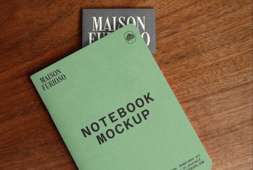 Mint green notebook with "Maison Furioso" branding, small leaf logo on cover, styled on wood surface with matching business card behind it