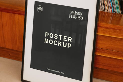 Black poster in wood frame between vintage filing cabinets showing elegant branding layout