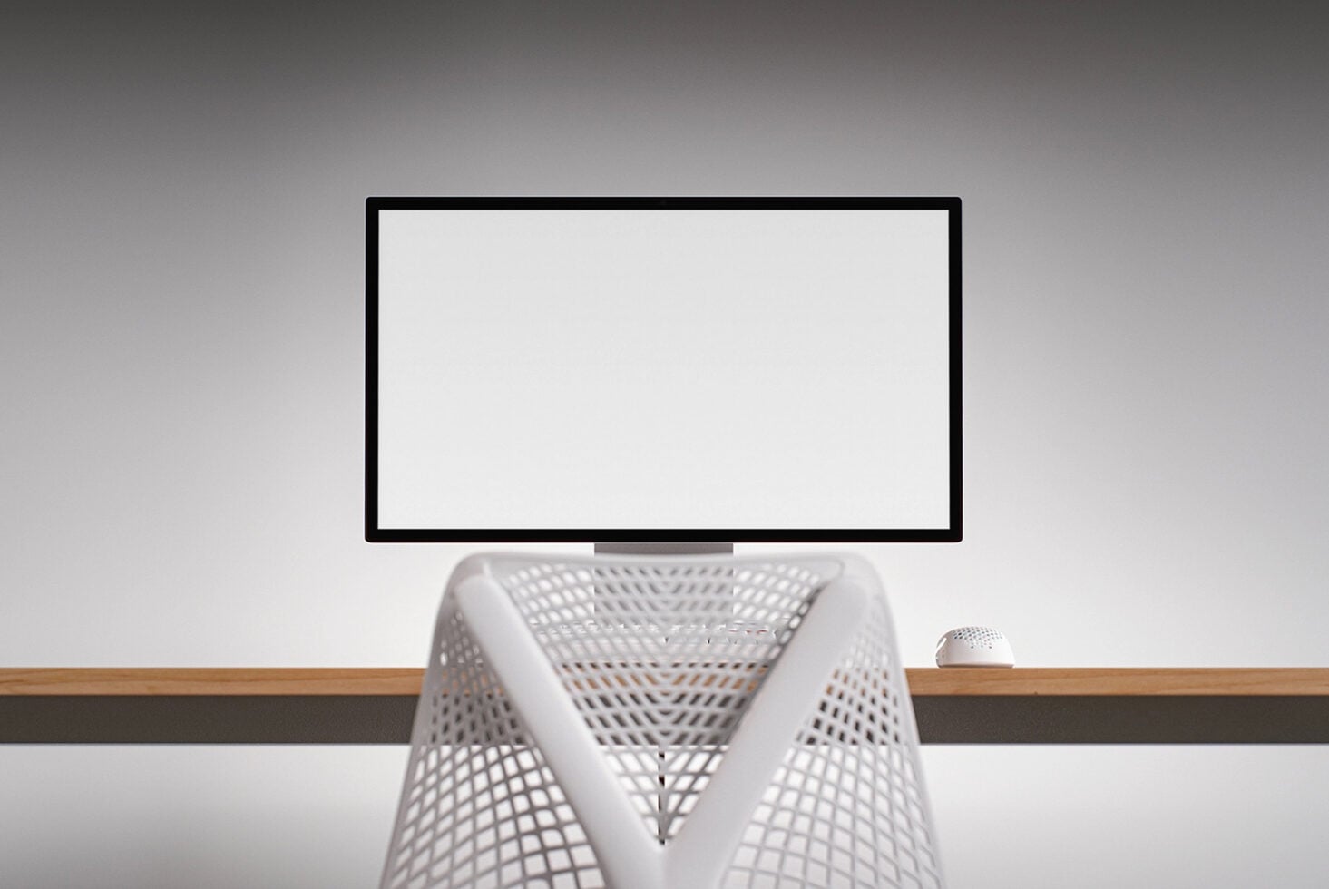 Monitor mockup with white mesh chair, wireless mouse on wooden desk