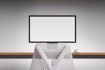 Monitor mockup with white mesh chair, wireless mouse on wooden desk