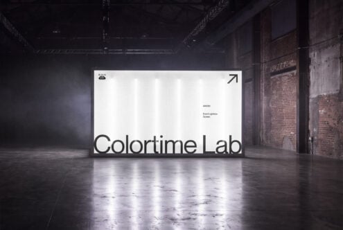 Large event lightbox screen mockup in industrial warehouse space with brick walls