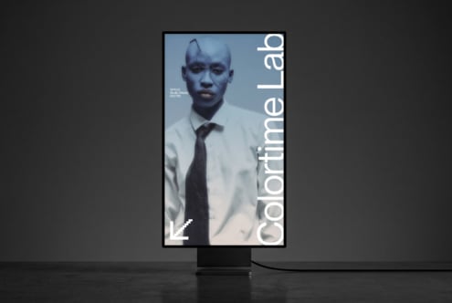 Vertical studio display mockup showing portrait of man in white shirt with tie on blue background