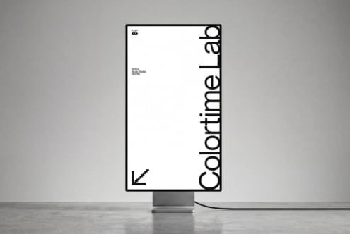 Vertical studio display mockup showing minimal branding layout with bold typography on screen