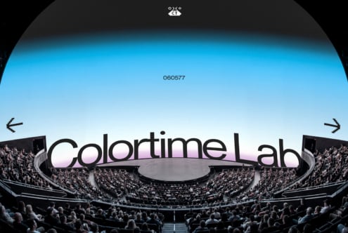 Futuristic stadium with glowing ColorTime Lab sign, packed crowd, blue sky gradient