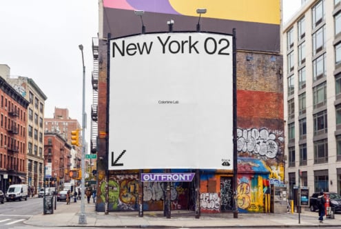 Large billboard mockup on NYC street with colorful awning, brick buildings, graffiti below, clean white space for text overlay