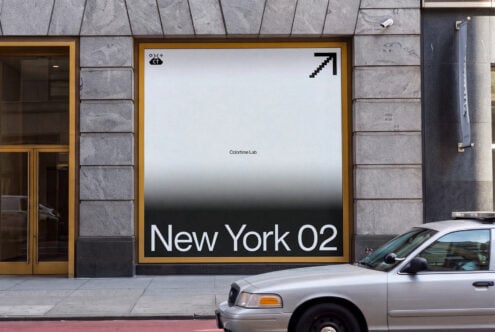 Street storefront mockup showing large framed poster with gradient background, minimal text, gold frame on stone facade