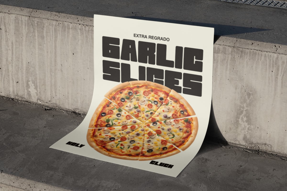 Folded pizza flyer mockup leaning against concrete wall with sliced pie photo