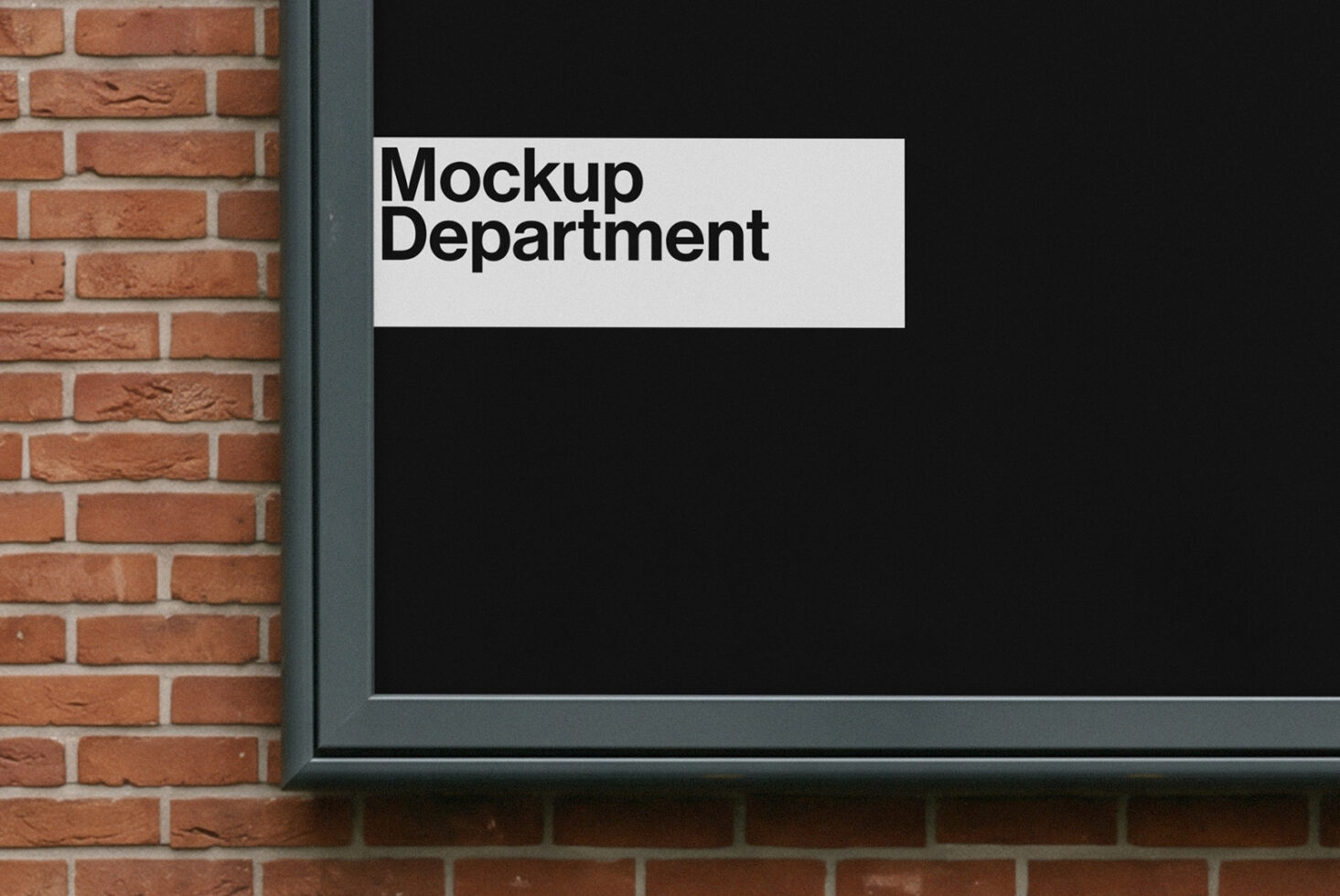 Storefront sign mockup with white horizontal rectangle on dark background next to red brick wall