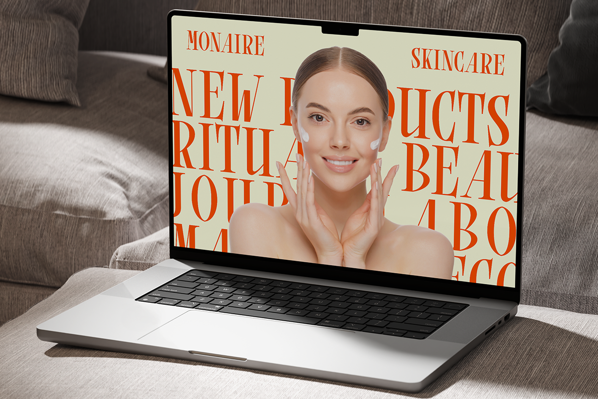Laptop mockup showing skincare brand website with orange typography, woman applying face cream on screen