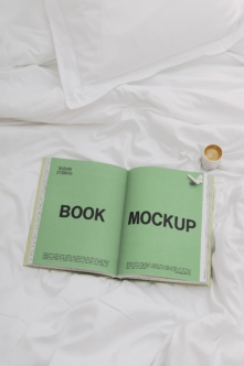 Open magazine spread with bright green pages on rumpled white bedding, coffee cup nearby