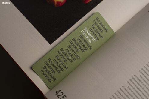 Sage green bookmark mockup lying on open book with text overlay showing repeating bookmark copy