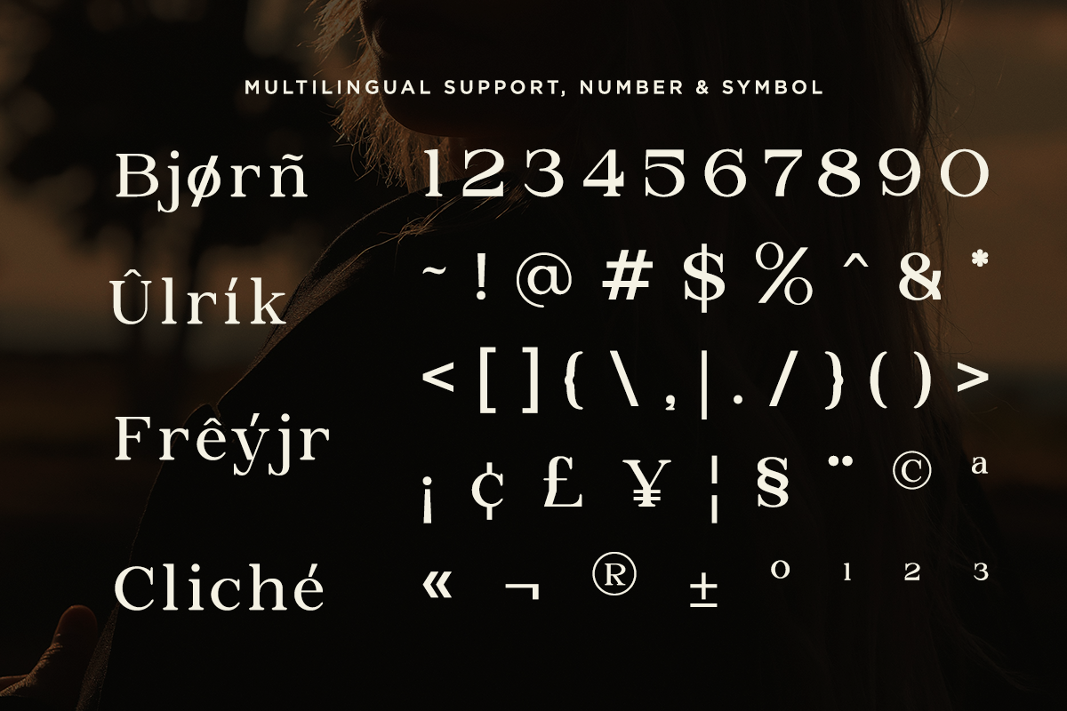 Serif typeface with Nordic characters, numbers, symbols, currency signs on dark moody background