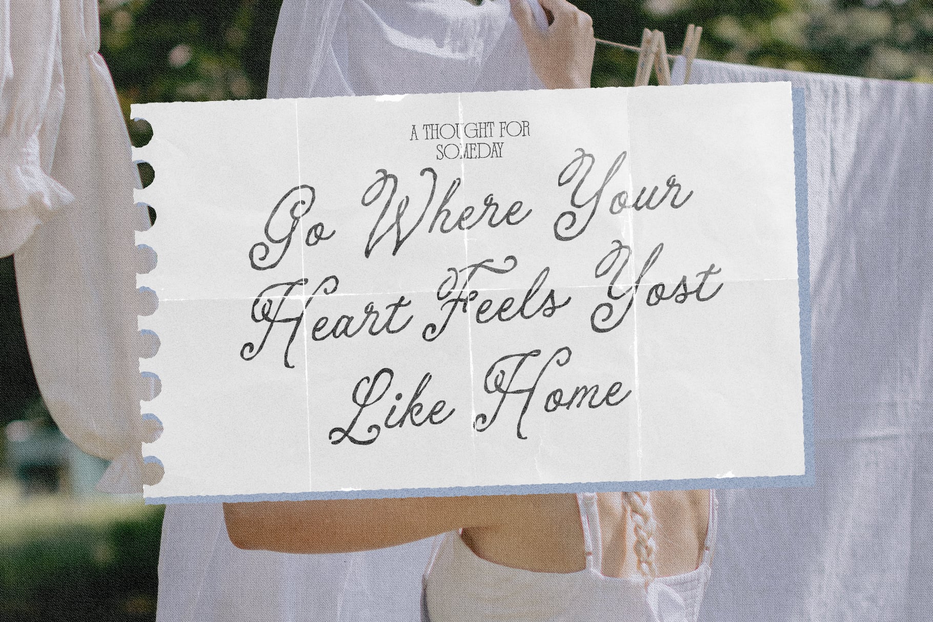Handwritten note clipped to clothesline with cursive script saying "Go Where Your Heart Feels Most Like Home"