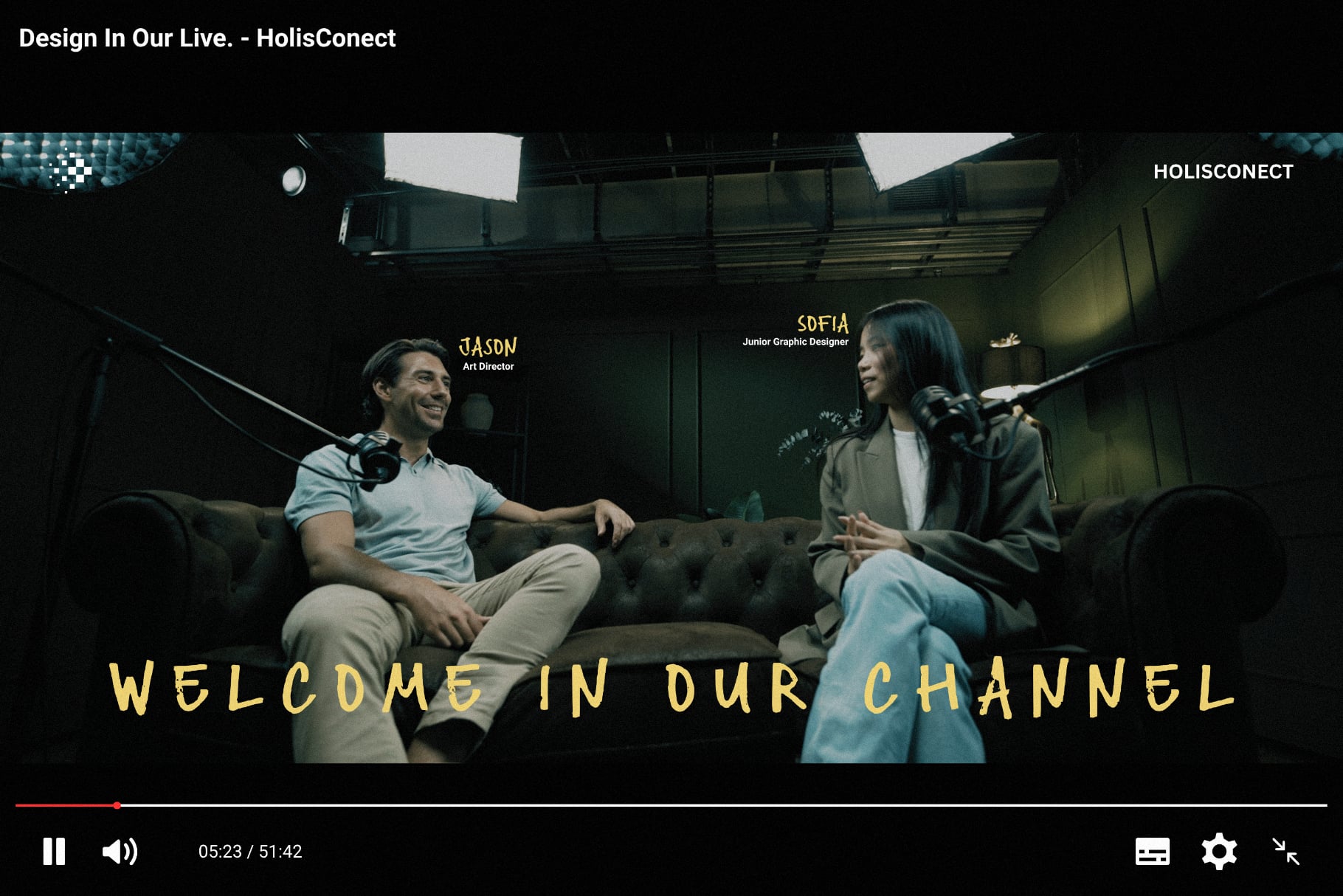 Two people chatting on studio couch with microphones, yellow text overlay reads welcome in our channel