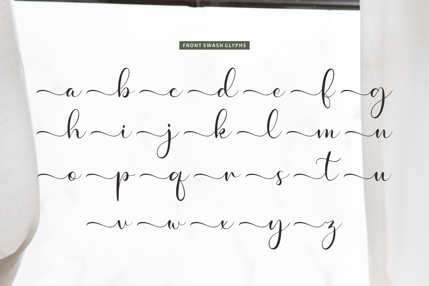 Elegant connected script alphabet with swooping flourishes between each letter