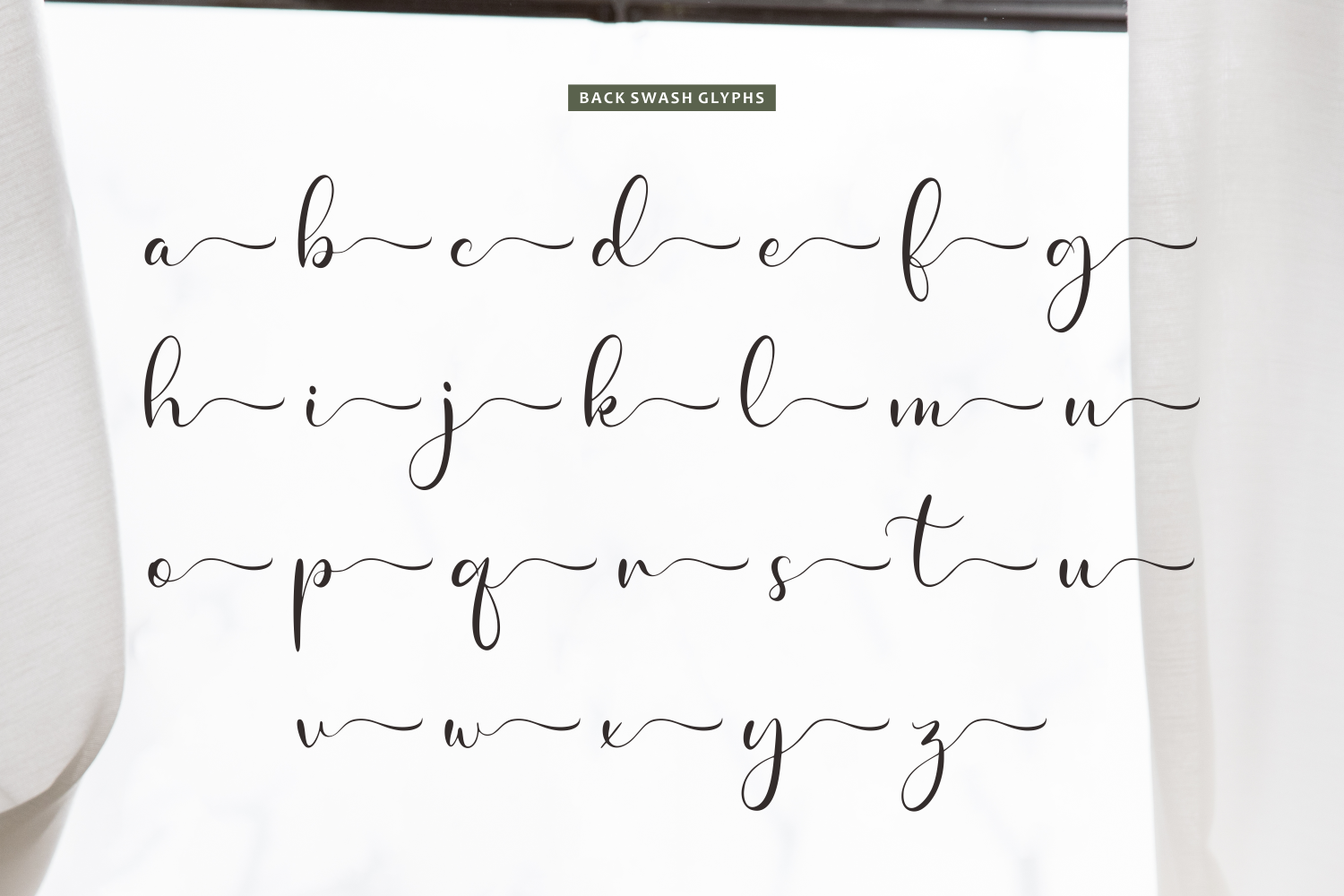 Handwritten lowercase alphabet with connected wavy underlines on white paper