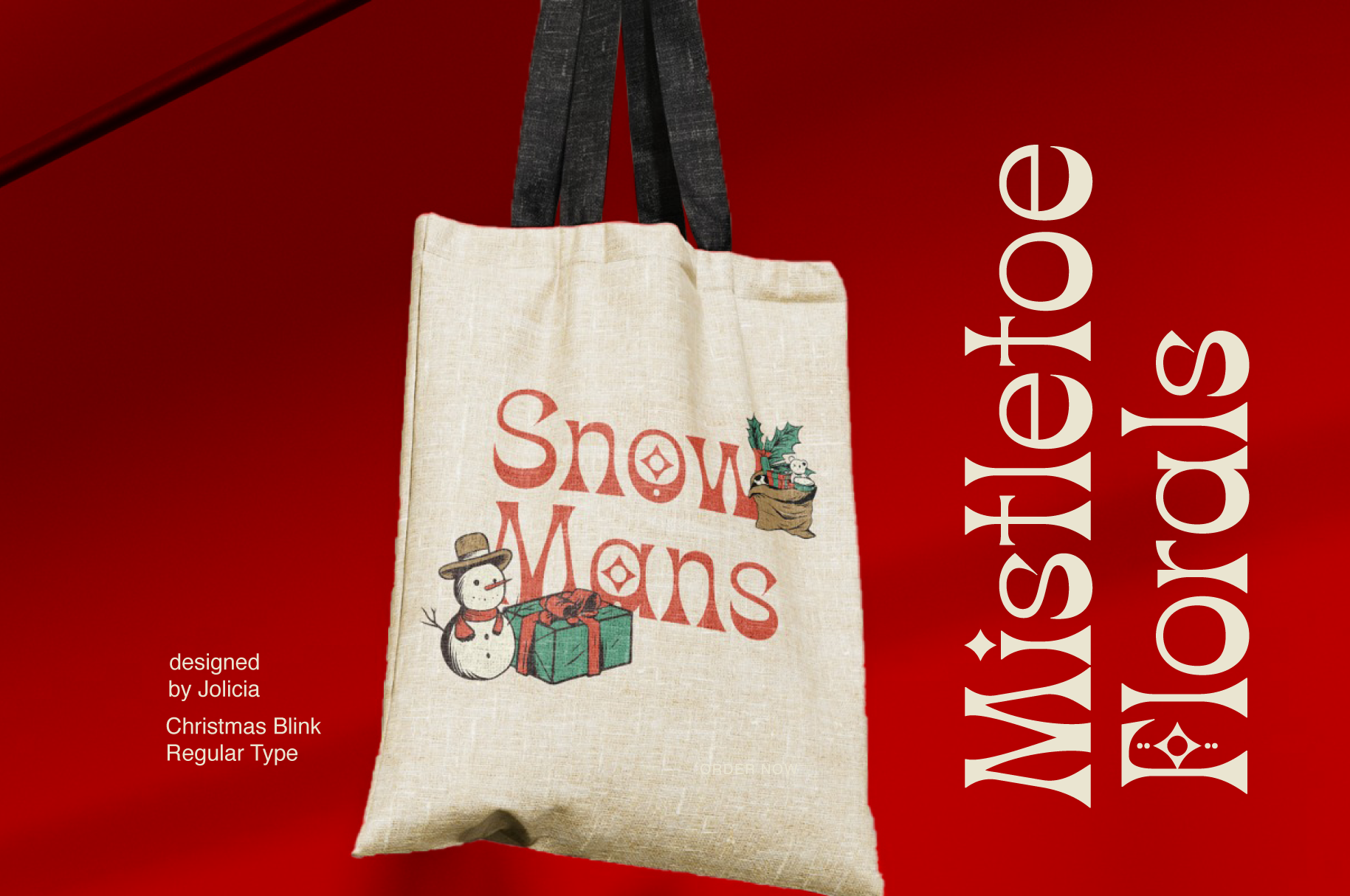 Cream canvas tote bag with "Snow Moms" text, snowman, gift box on bright red background