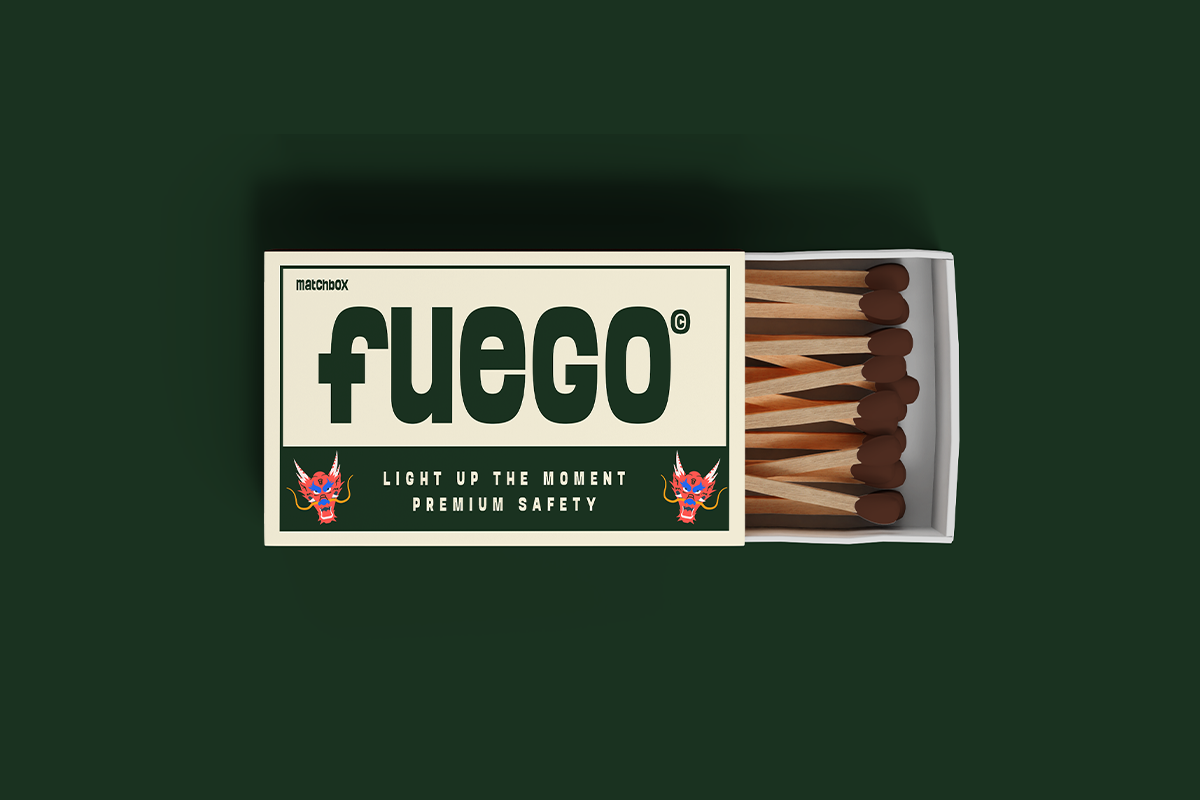 Retro matchbox mockup with cream label, dark green fuego branding, tiny flame icons, wooden matches visible inside