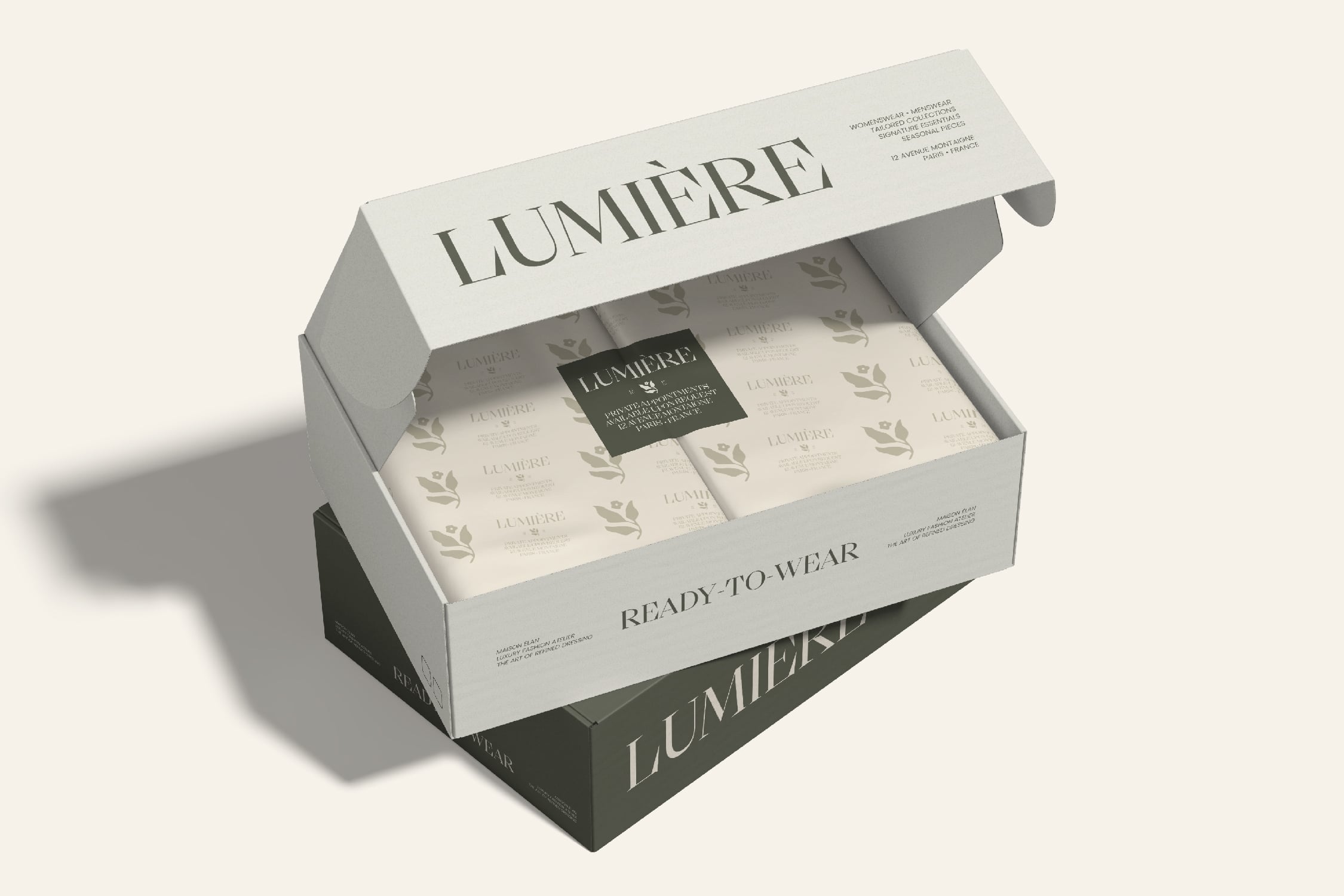 Opened luxury packaging box showing folded garments with brand label inside