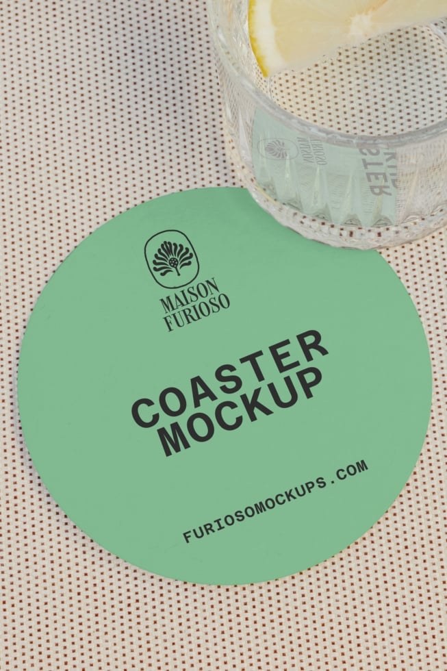 Mint green circular coaster mockup with logo, shot flat lay with white mesh tape roll on textured background