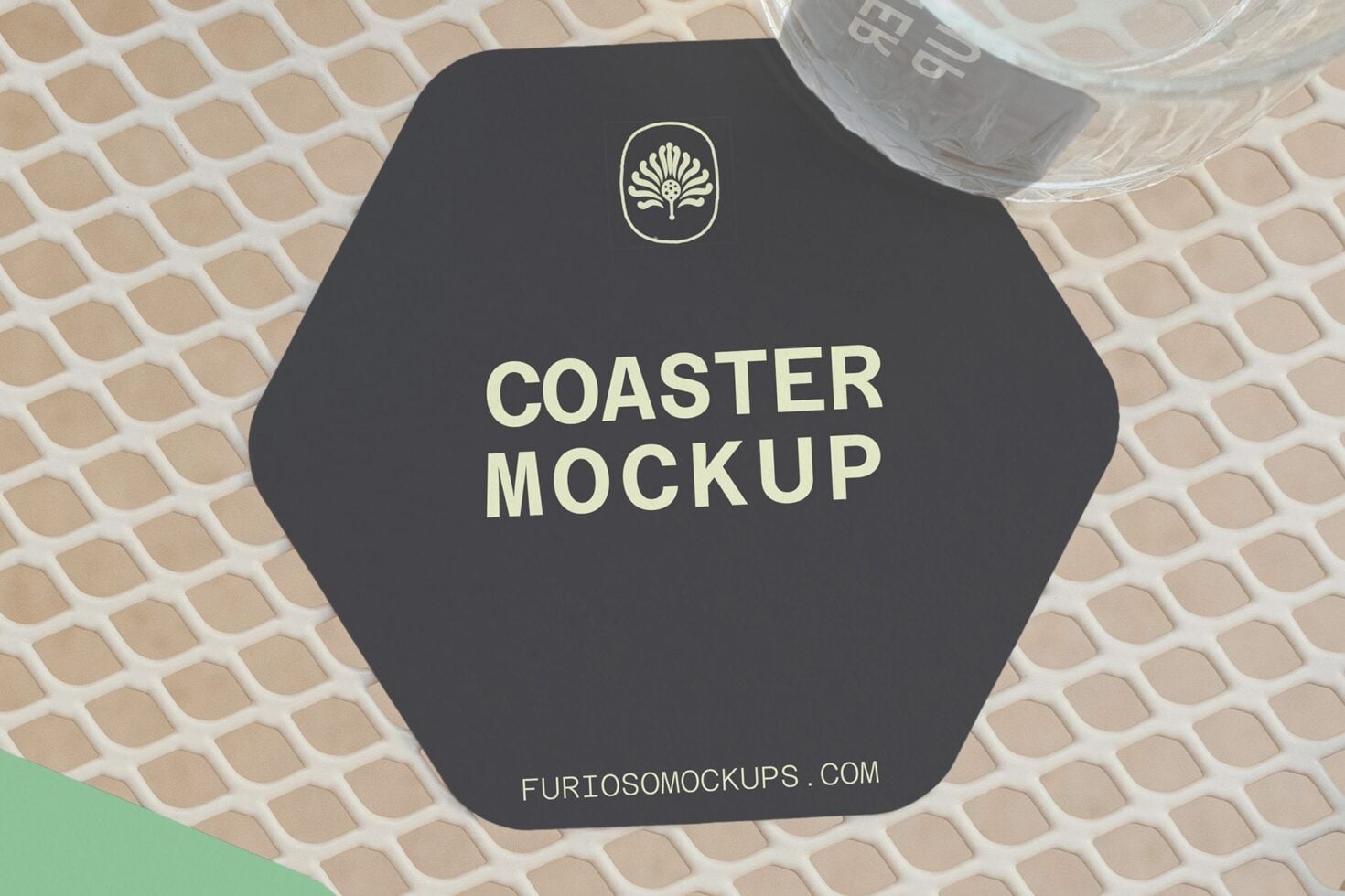 Dark hexagonal coaster with cream text, shell logo, styled with glass on woven backdrop