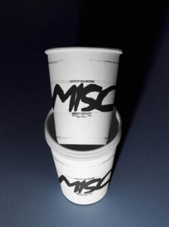 Stacked paper cups mockup with bold black graffiti lettering on white sleeves, dark background