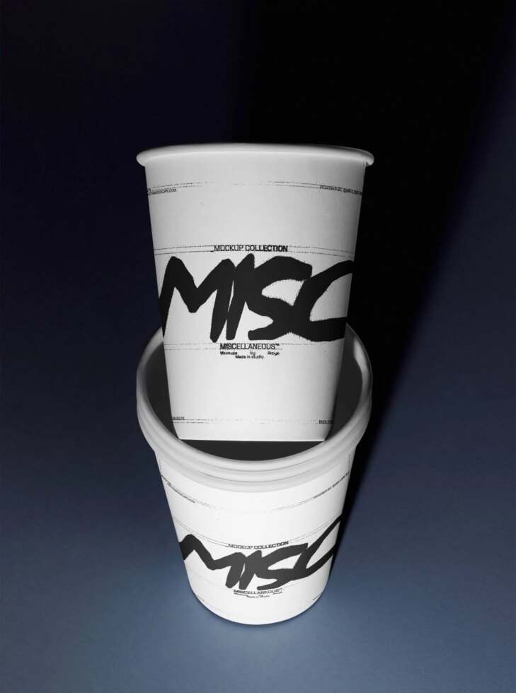 Stacked paper cups mockup with bold black graffiti lettering on white sleeves, dark background