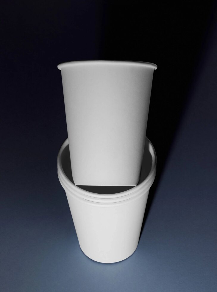 Blank white paper coffee cup mockup stacked on dark background