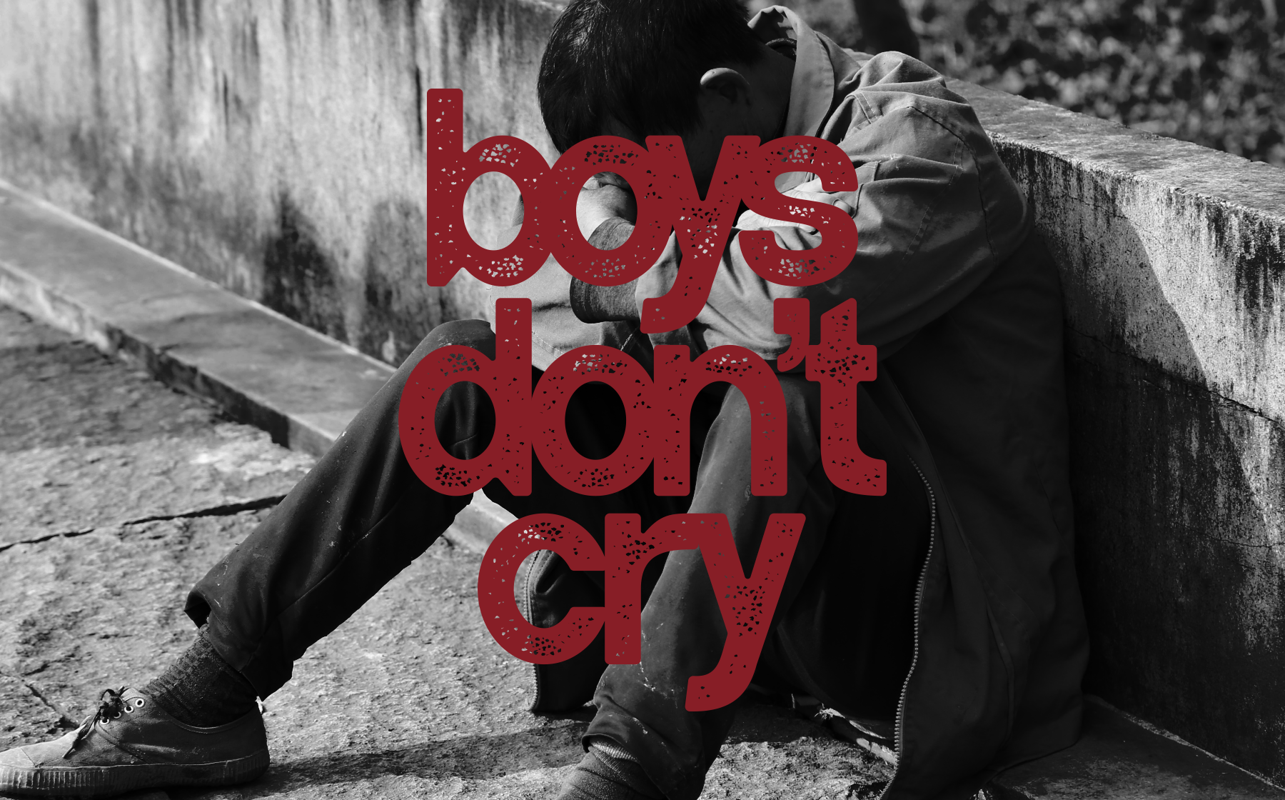 Bold red textured typography saying "boys don't cry" layered over black white photo of person sitting against concrete wall