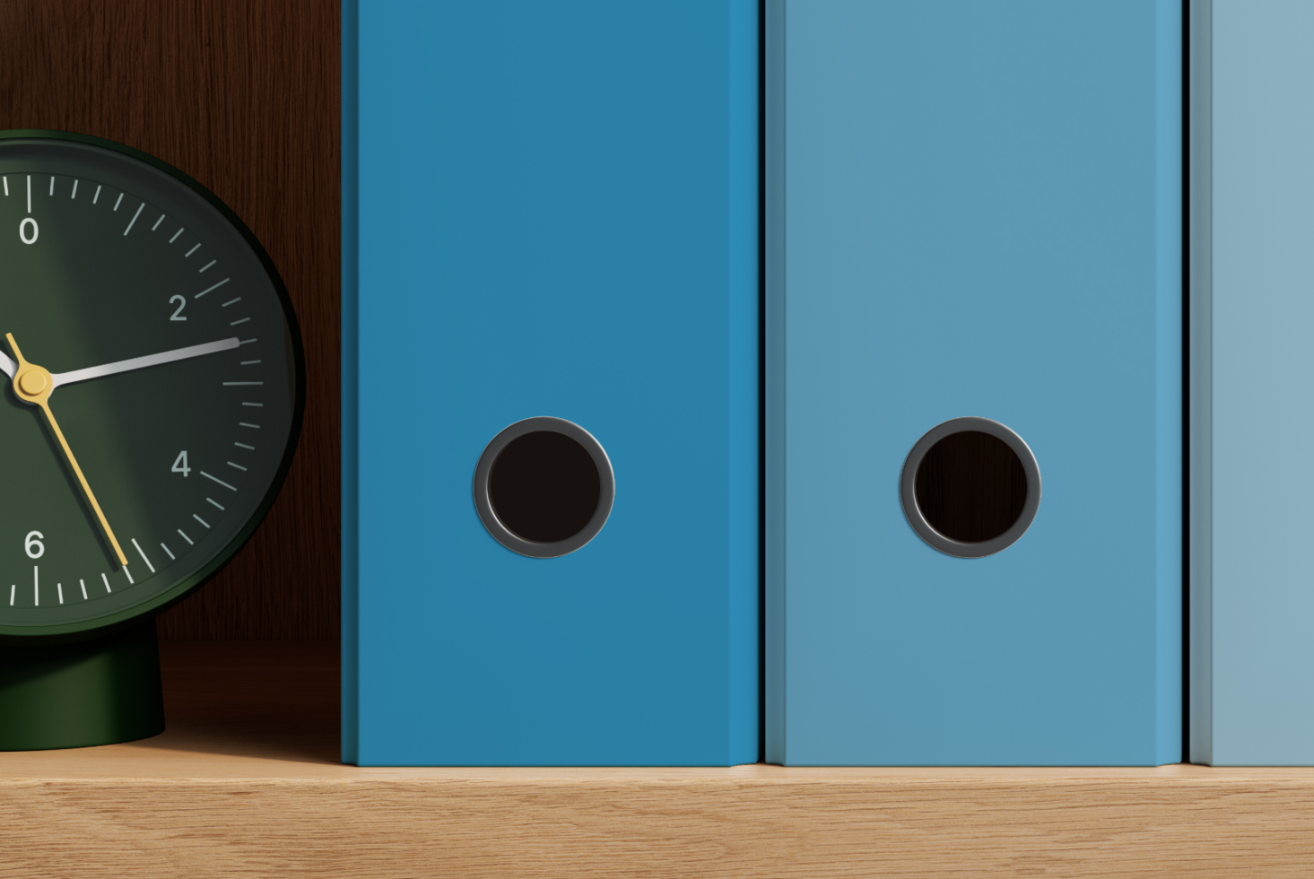 Minimalist desk setup with vintage clock, blue books, wooden surface, metallic accents