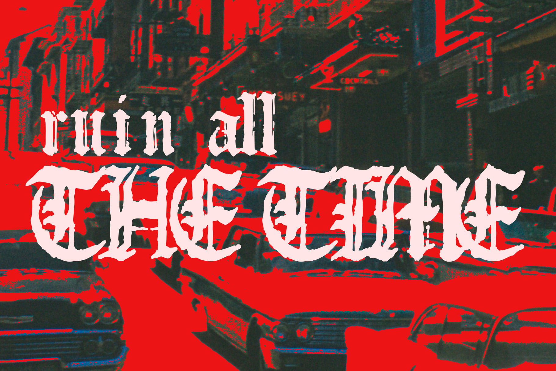 Distorted white gothic typeface over red glitch effect with dark urban street photo backdrop