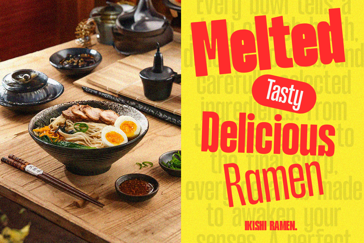 Ramen bowl with noodles, soft boiled eggs, toppings on wooden table with chopsticks