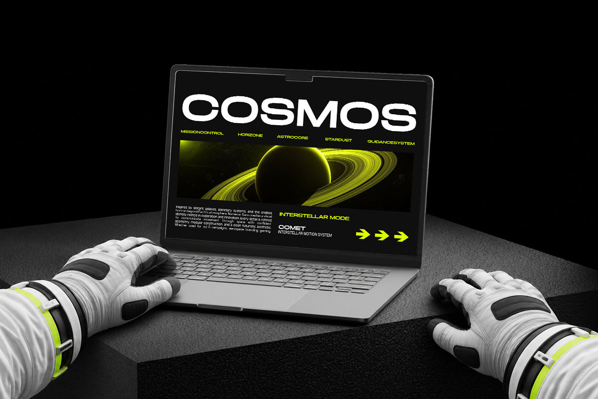 Laptop displaying bold COSMOS website design with glowing planet imagery, neon yellow type, paired with futuristic white gloves