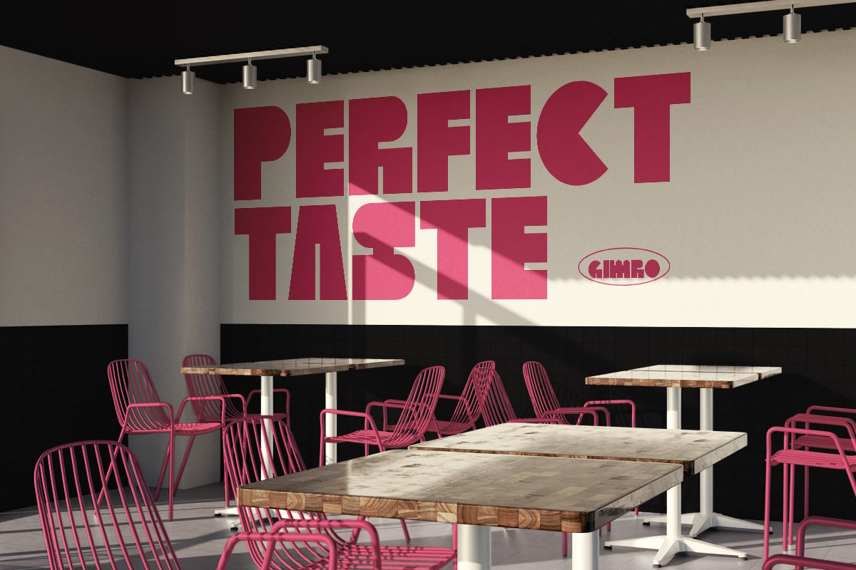 Modern cafe interior with pink chairs, wooden tables, track lighting, bold red "Perfect Taste" typography on beige wall