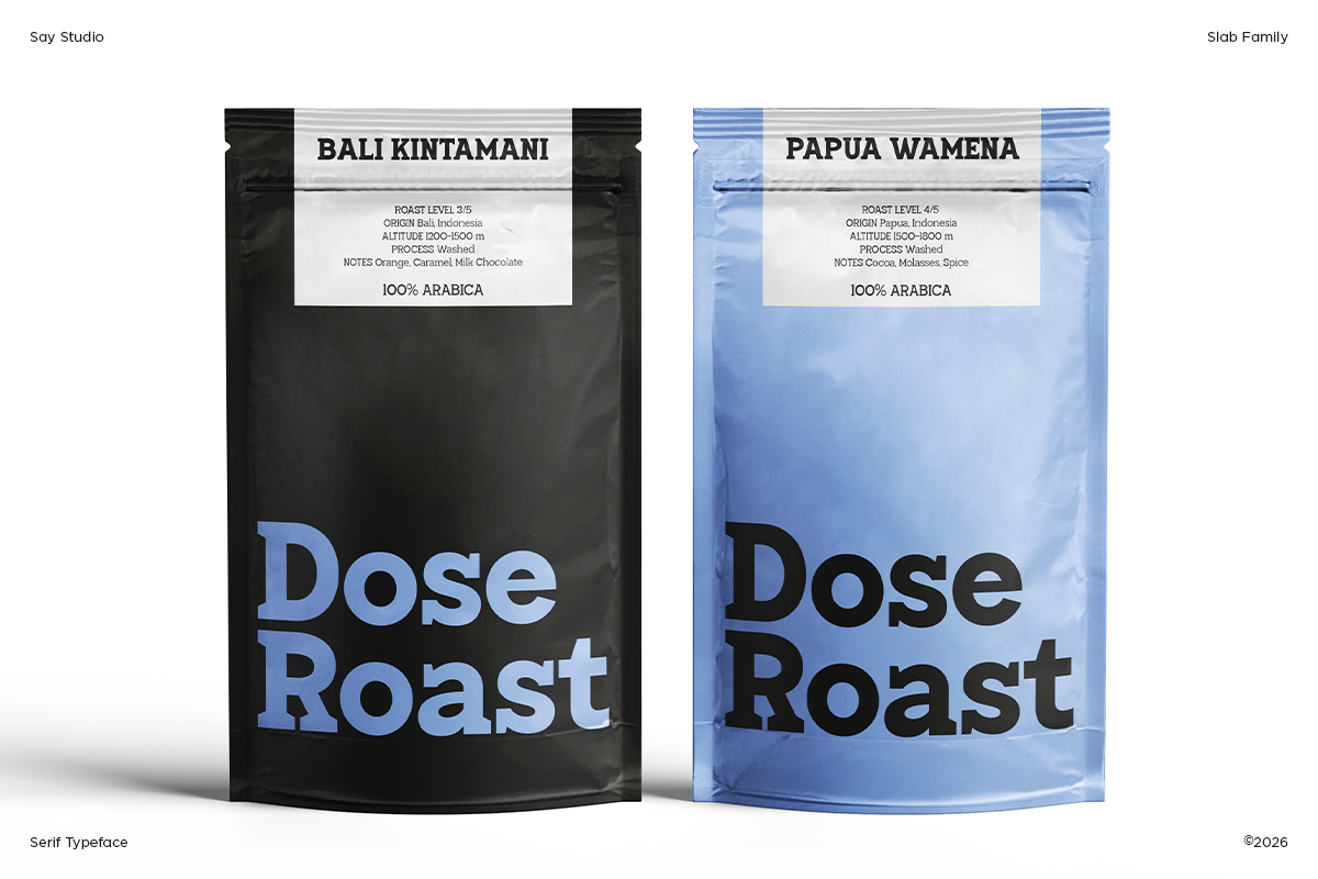 Two coffee pouches for Dose Roast showing black Bali Kintamani bag next to blue Papua Wamena bag with detailed labels
