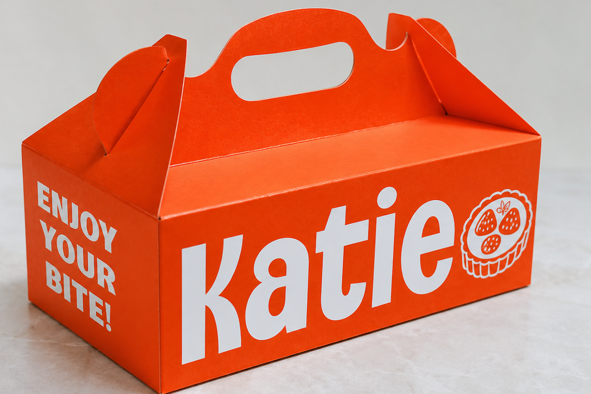 Bright red takeout box mockup with handle, "Enjoy Your Bite" text, pastry icon on side