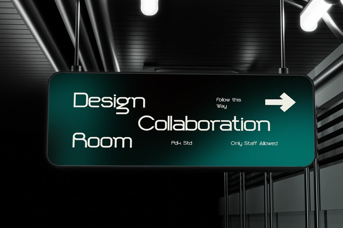 Glowing teal neon sign hanging in modern office hallway reading "Design Collaboration Room"