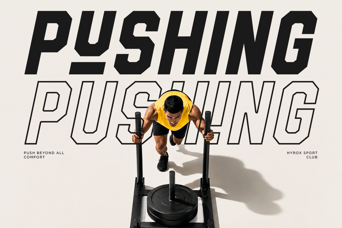Overhead shot of athlete on rowing machine wearing yellow hoodie with bold "PUSHING PUSHING" typography overlay