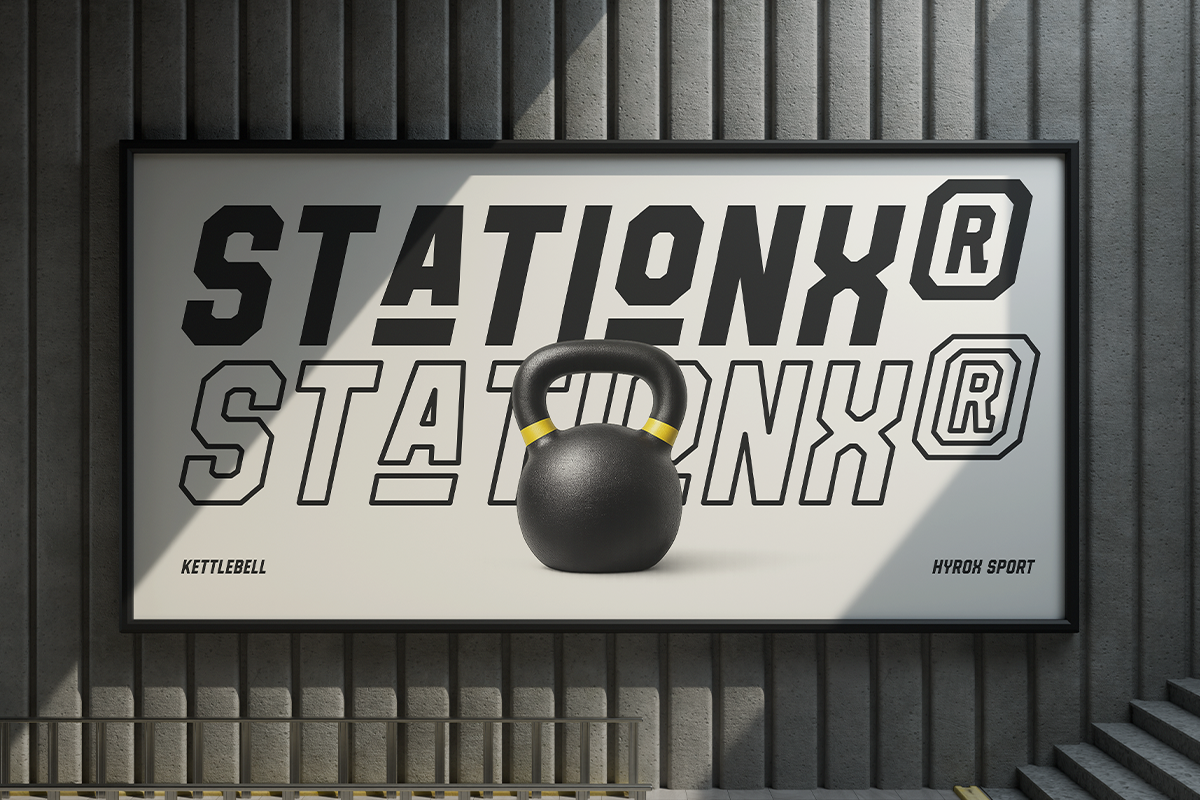 Black kettlebell centered on gym storefront sign with bold outlined typography