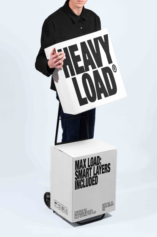 Man holding heavy load poster mockup with shipping box below showing smart layers included