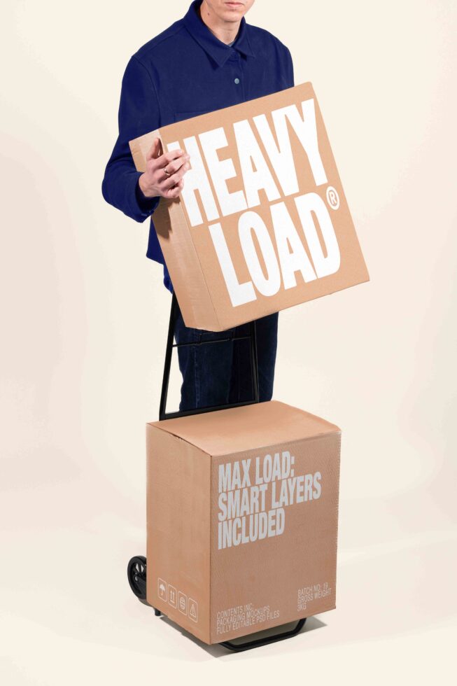Man in navy shirt holding cardboard box mockup with heavy load branding