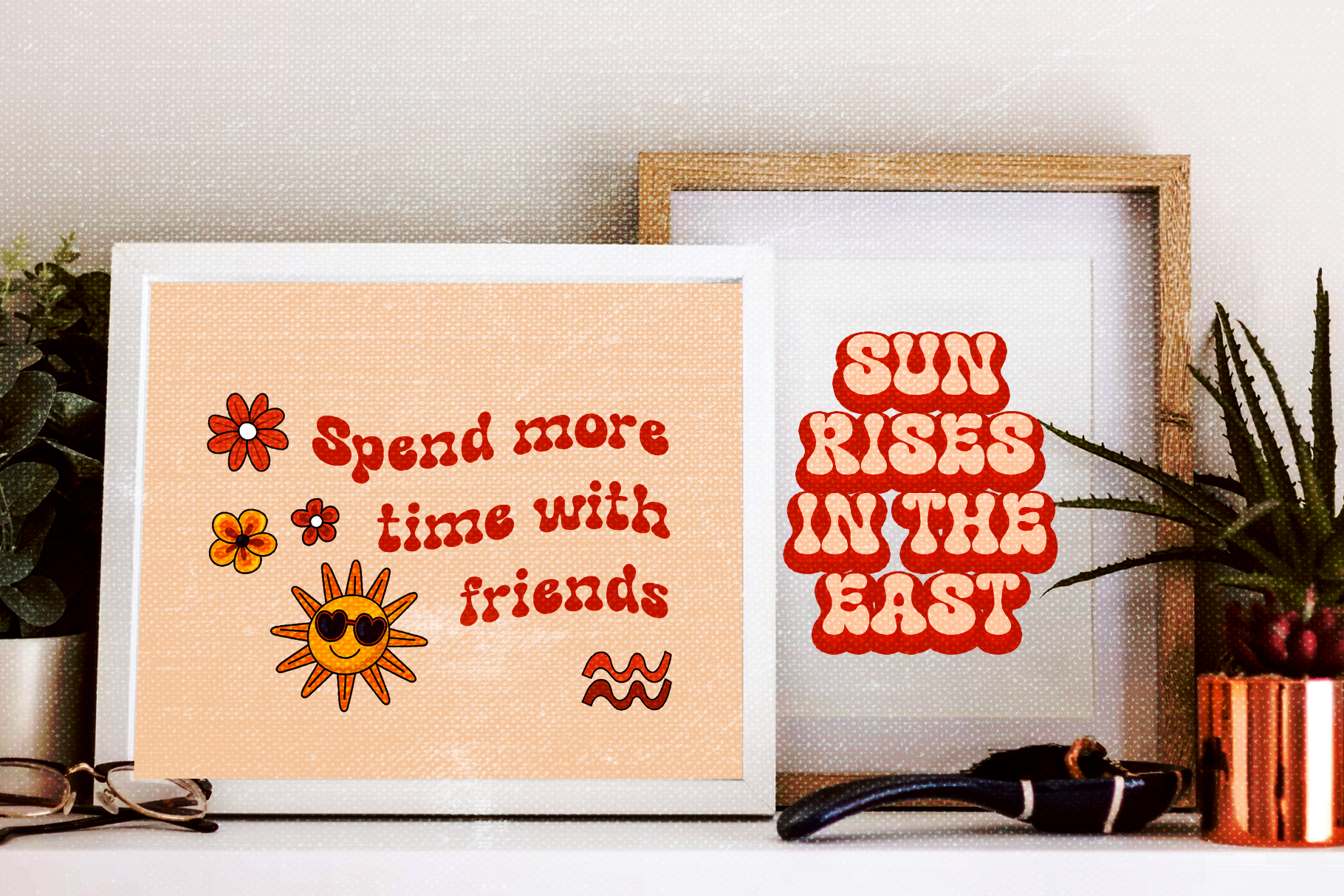 Two retro-style framed prints with groovy red bubble lettering on peachy backgrounds surrounded by plants