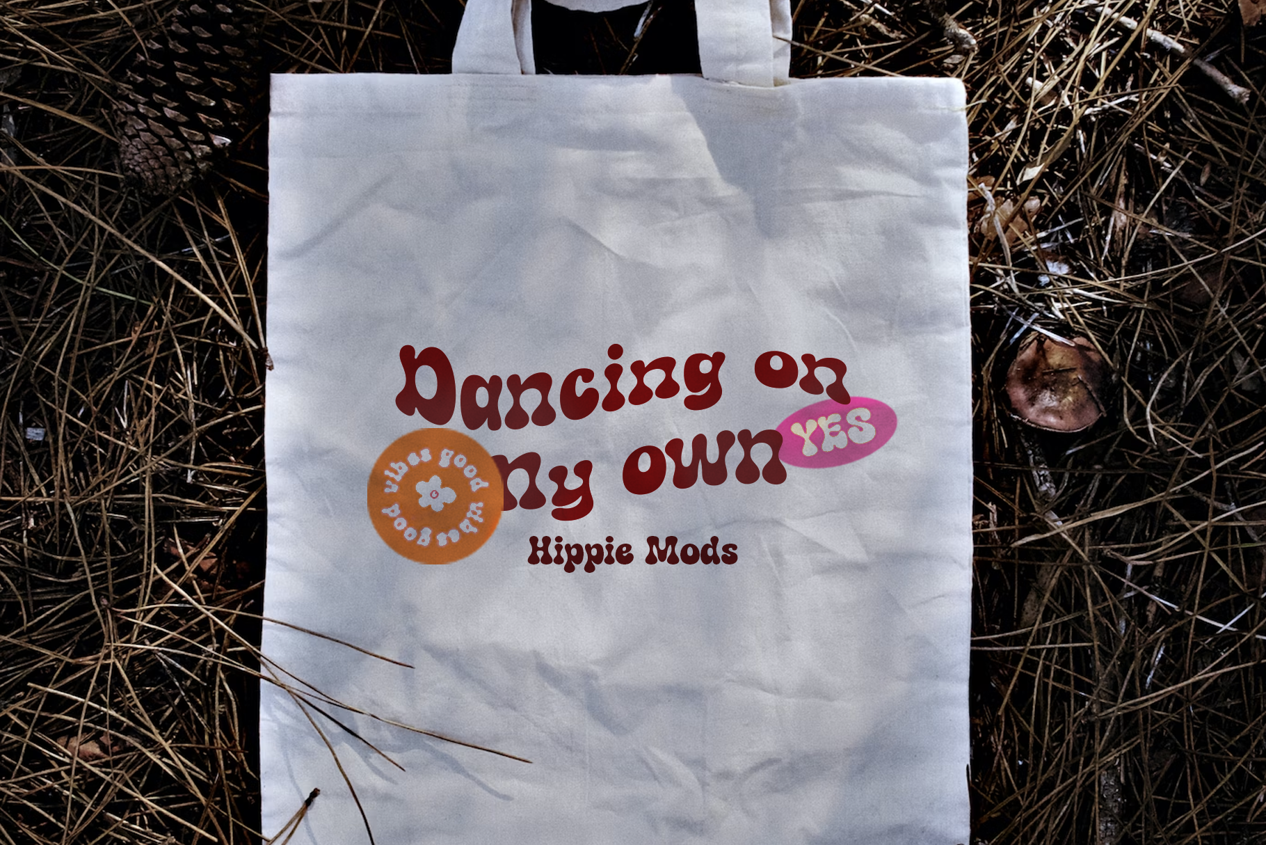 White canvas tote bag with retro groovy text saying Dancing on my own yes, Hippie Mods logo