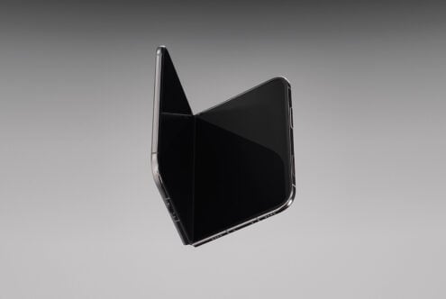 Foldable phone mockup with open display on neutral gray background, angled view